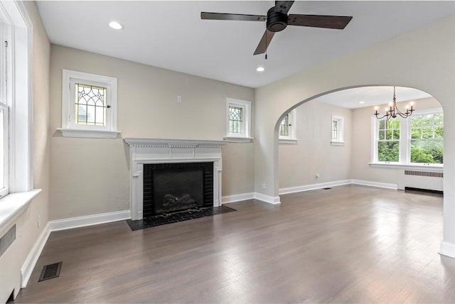 426 Pasadena Ave, Webster Groves, MO 63119 - unfurnished living room featuring radiator, a chandelier, healthy amount of natural light, wood finished floors, and recessed lighting