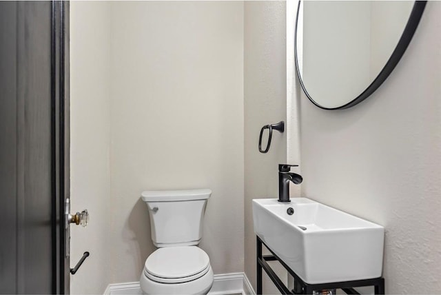 426 Pasadena Ave, Webster Groves, MO 63119 - half bath featuring toilet, baseboards, and a sink