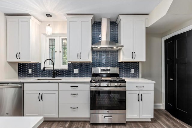 426 Pasadena Ave, Webster Groves, MO 63119 - kitchen with stainless steel appliances, wall chimney exhaust hood, a sink, white cabinetry, and dark wood-style floors