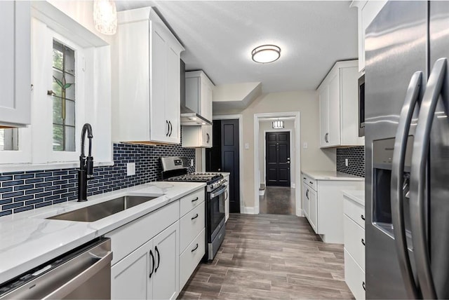 426 Pasadena Ave, Webster Groves, MO 63119 - kitchen with appliances with stainless steel finishes, a sink, white cabinets, and backsplash