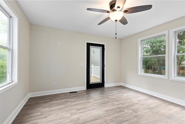 426 Pasadena Ave, Webster Groves, MO 63119 - unfurnished room featuring healthy amount of natural light, a ceiling fan, light wood finished floors, and baseboards