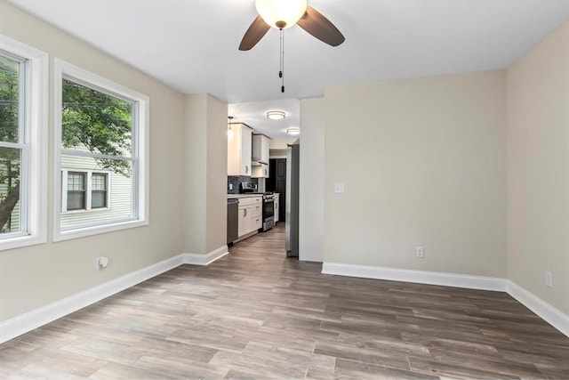 426 Pasadena Ave, Webster Groves, MO 63119 - unfurnished living room featuring a ceiling fan, wood finished floors, and baseboards