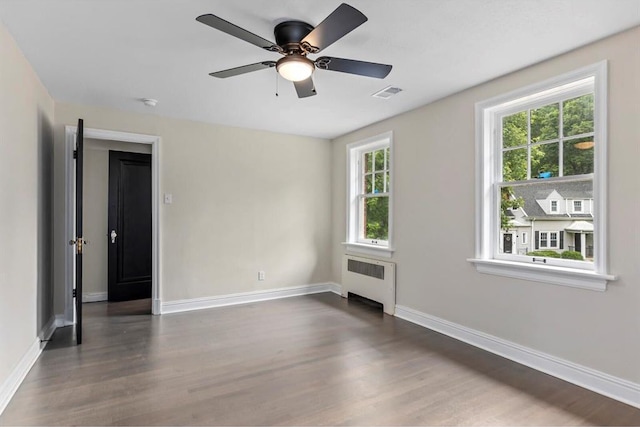 426 Pasadena Ave, Webster Groves, MO 63119 - unfurnished room with radiator, dark wood finished floors, baseboards, and a ceiling fan