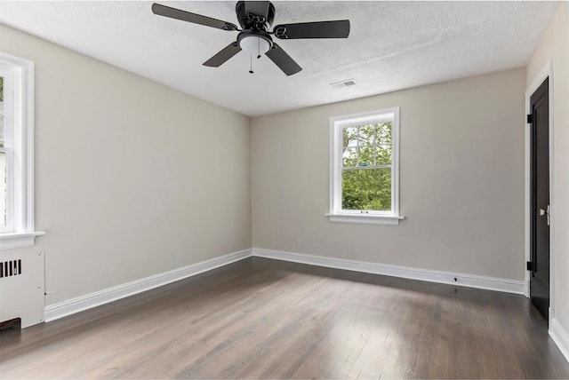426 Pasadena Ave, Webster Groves, MO 63119 - spare room with dark wood-style floors, baseboards, a ceiling fan, radiator, and a textured ceiling