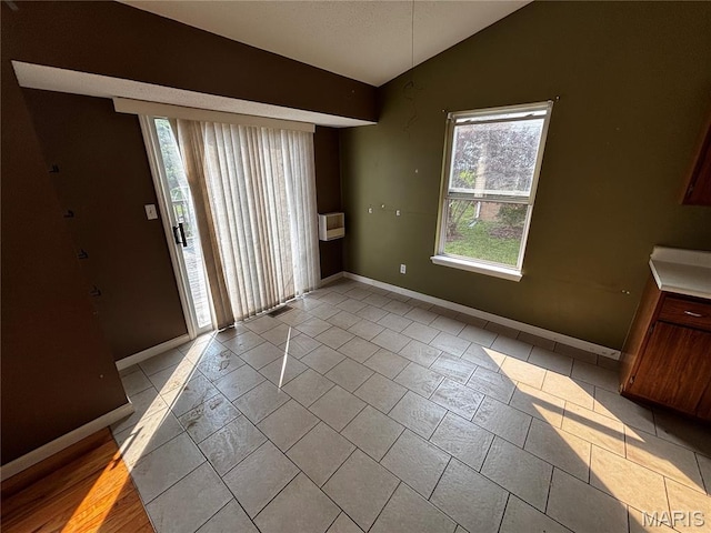 7764 Locust Dr, Barnhart, MO 63012 - unfurnished dining area featuring vaulted ceiling and baseboards
