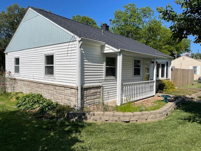 212 E N St, Benton, MO 63736 - view of property exterior featuring covered porch, roof with shingles, and a chimney