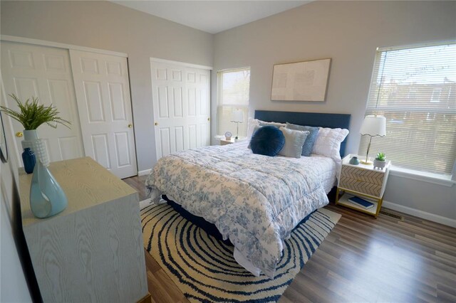 2922 Pennsylvania Ave, Saint Louis, MO 63118 - bedroom with baseboards, wood finished floors, and two closets