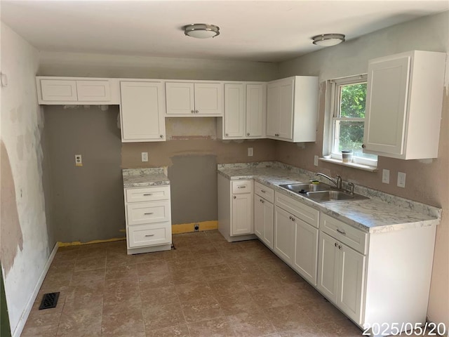13083 Hencher Rd, De Soto, MO 63020 - kitchen with a sink, white cabinets, baseboards, and light countertops