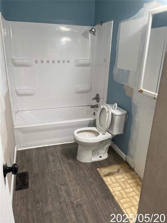 13083 Hencher Rd, De Soto, MO 63020 - full bath with wood finished floors, toilet, and washtub / shower combination