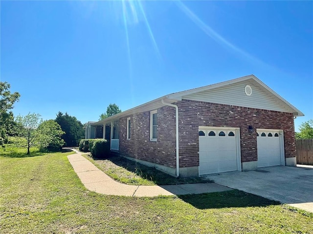 17250 Brewster Ln, Crocker, MO 65452 - view of side of home featuring concrete driveway, an attached garage, a lawn, and brick siding