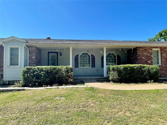 17250 Brewster Ln, Crocker, MO 65452 - view of front of property featuring a porch and a front lawn