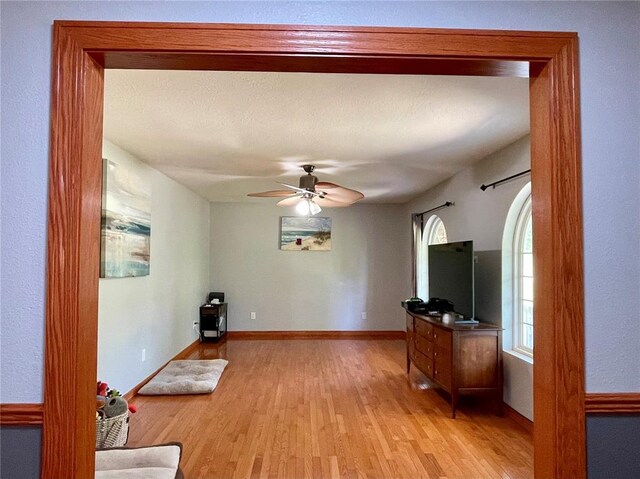 17250 Brewster Ln, Crocker, MO 65452 - living room with light wood-type flooring, ceiling fan, and baseboards