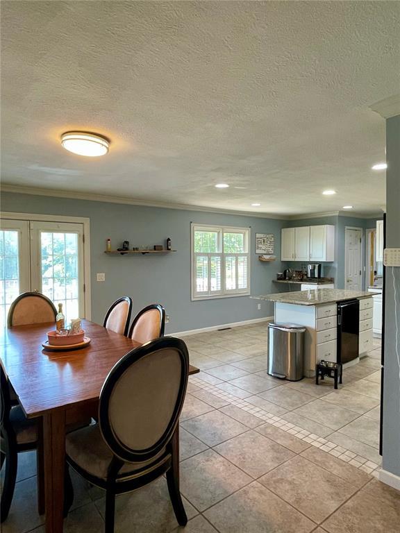 17250 Brewster Ln, Crocker, MO 65452 - dining space featuring baseboards, crown molding, light tile patterned floors, a textured ceiling, and recessed lighting
