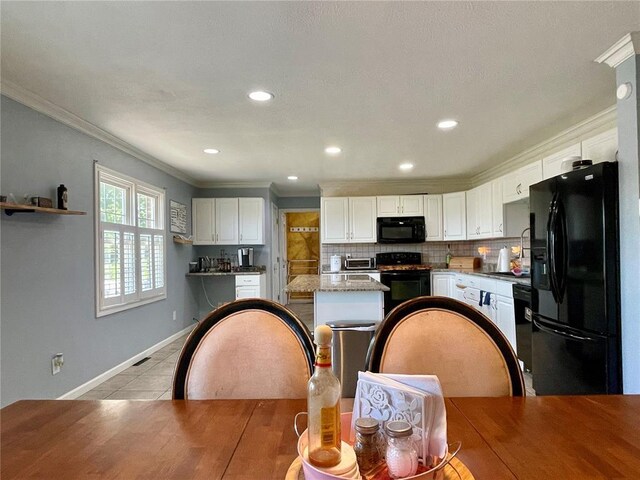 17250 Brewster Ln, Crocker, MO 65452 - kitchen with black appliances, ornamental molding, white cabinetry, tasteful backsplash, and light stone counters