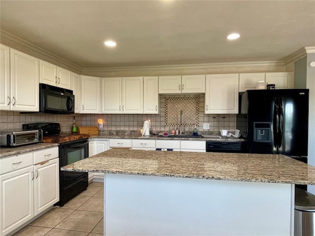 17250 Brewster Ln, Crocker, MO 65452 - kitchen with black appliances, crown molding, white cabinetry, a kitchen island, and tasteful backsplash