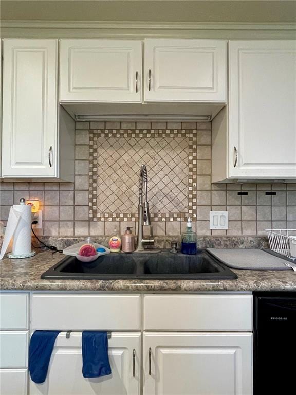17250 Brewster Ln, Crocker, MO 65452 - kitchen with black dishwasher, a sink, and tasteful backsplash
