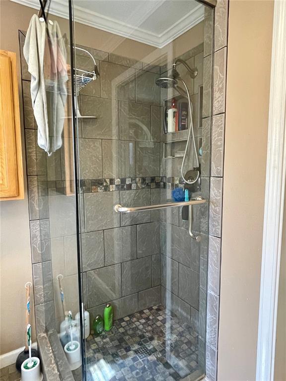 17250 Brewster Ln, Crocker, MO 65452 - bathroom with crown molding, a shower stall, and baseboards