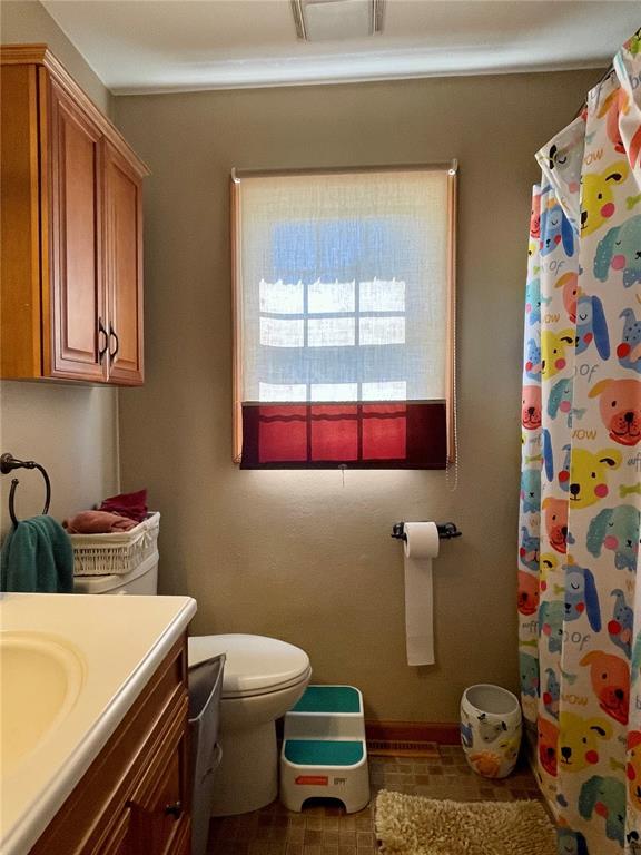 17250 Brewster Ln, Crocker, MO 65452 - full bath featuring vanity, toilet, curtained shower, and baseboards