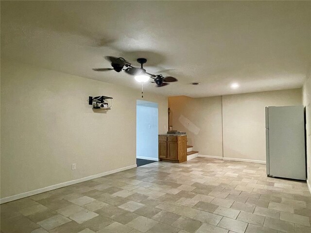 17250 Brewster Ln, Crocker, MO 65452 - unfurnished living room with a ceiling fan, stairs, and baseboards