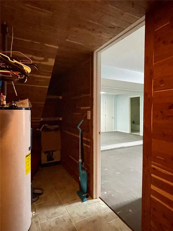 17250 Brewster Ln, Crocker, MO 65452 - hall with water heater, wood ceiling, and tile patterned floors