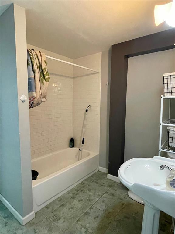 17250 Brewster Ln, Crocker, MO 65452 - bathroom with baseboards, bathtub / shower combination, and a sink