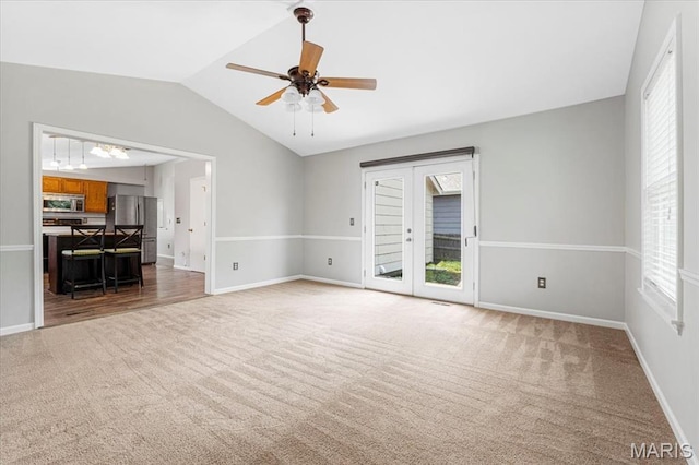 459 Xavier Ct, Valley Park, MO 63088 - unfurnished living room with light carpet, plenty of natural light, vaulted ceiling, ceiling fan, and baseboards