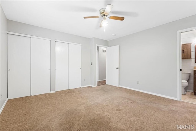 459 Xavier Ct, Valley Park, MO 63088 - unfurnished bedroom featuring multiple closets, carpet flooring, ensuite bathroom, baseboards, and ceiling fan