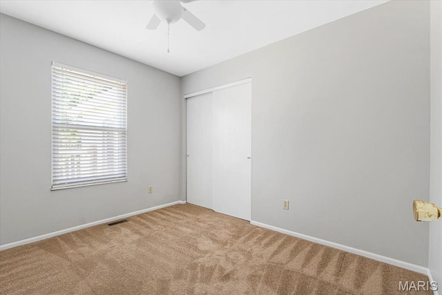 459 Xavier Ct, Valley Park, MO 63088 - unfurnished bedroom with carpet floors, a closet, baseboards, and a ceiling fan