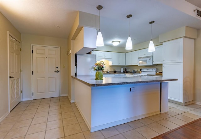 1300 N Main St Unit 213, Sikeston, MO 63801 - kitchen featuring white appliances, white cabinets, a peninsula, and baseboards