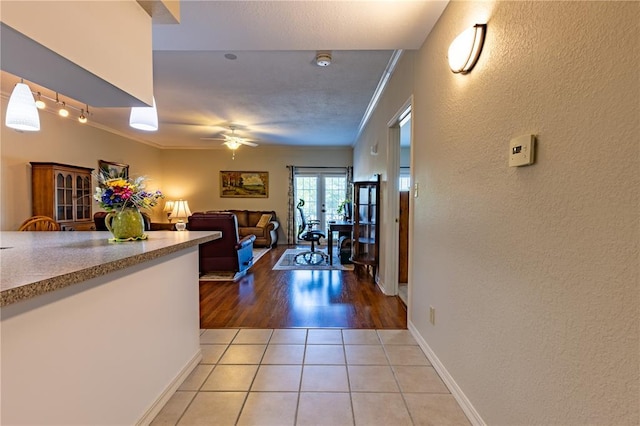 1300 N Main St Unit 213, Sikeston, MO 63801 - corridor with french doors, crown molding, a textured wall, light tile patterned floors, and baseboards