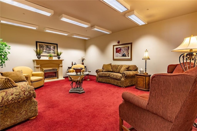 1300 N Main St Unit 213, Sikeston, MO 63801 - living room featuring a fireplace with raised hearth and carpet floors