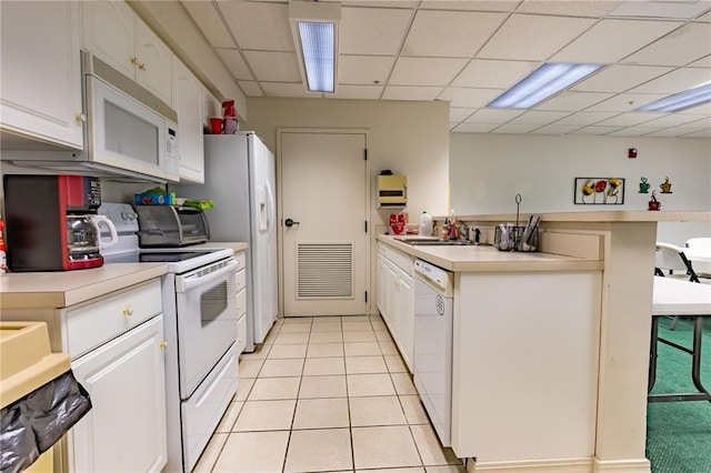 1300 N Main St Unit 213, Sikeston, MO 63801 - kitchen with white appliances, light countertops, a sink, white cabinetry, and a paneled ceiling