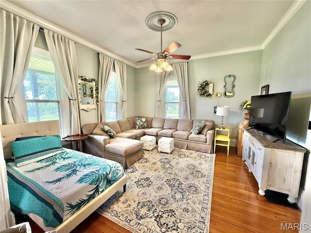 714 Farrar St, Fredericktown, MO 63645 - living area featuring wood finished floors, ornamental molding, and a ceiling fan