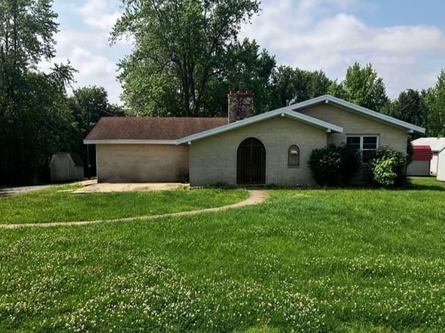 15606 County Road 624, Dexter, MO 63841 - single story home with a chimney, a front yard, and brick siding