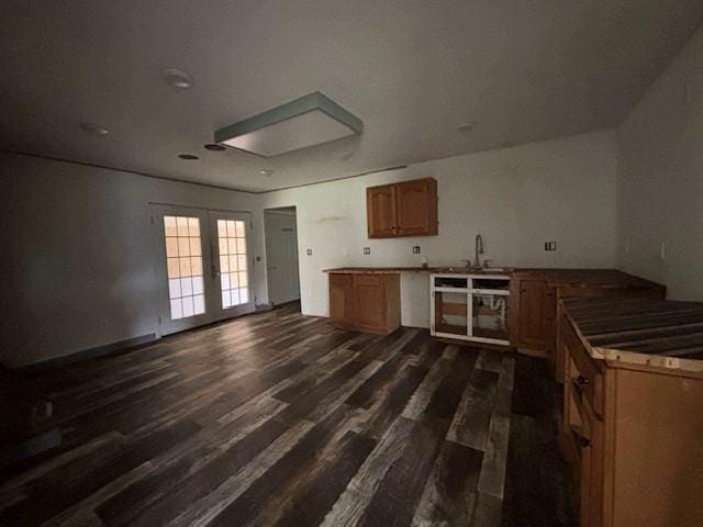 15606 County Road 624, Dexter, MO 63841 - kitchen featuring french doors, dark wood-style flooring, brown cabinetry, and a sink
