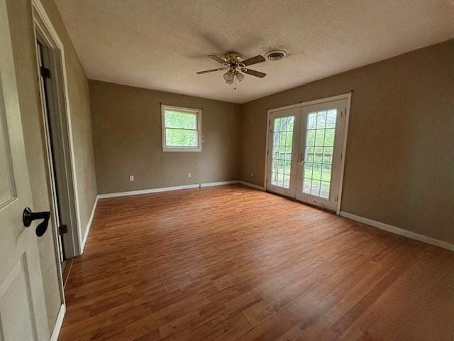 15606 County Road 624, Dexter, MO 63841 - spare room with wood finished floors, ceiling fan, baseboards, a textured ceiling, and french doors