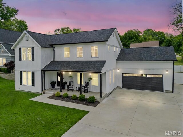 28 Millwell Dr, Maryland Heights, MO 63043 - modern inspired farmhouse featuring a porch, concrete driveway, a garage, and a front lawn