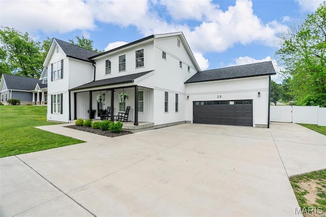 28 Millwell Dr, Maryland Heights, MO 63043 - modern inspired farmhouse featuring a porch, driveway, a garage, a shingled roof, and a gate