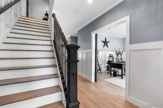 28 Millwell Dr, Maryland Heights, MO 63043 - stairs featuring crown molding, wood finished floors, a decorative wall, and wainscoting