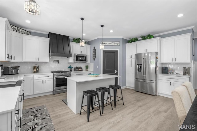 28 Millwell Dr, Maryland Heights, MO 63043 - kitchen with high quality appliances, custom exhaust hood, ornamental molding, backsplash, and a kitchen bar