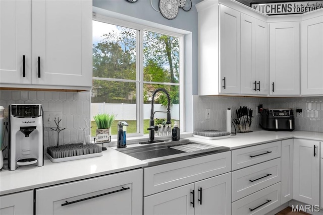 28 Millwell Dr, Maryland Heights, MO 63043 - kitchen featuring white cabinets, light countertops, and tasteful backsplash