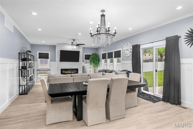 28 Millwell Dr, Maryland Heights, MO 63043 - dining area with ceiling fan, a high end fireplace, ornamental molding, light wood-type flooring, and a chandelier
