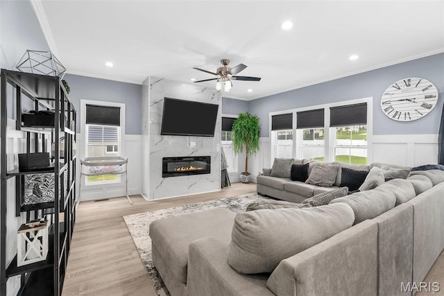 28 Millwell Dr, Maryland Heights, MO 63043 - living area featuring crown molding, a ceiling fan, recessed lighting, a wainscoted wall, and a fireplace