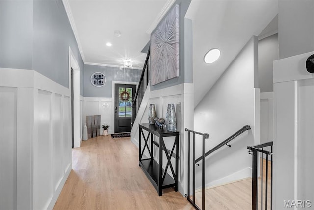 28 Millwell Dr, Maryland Heights, MO 63043 - hall with an upstairs landing, ornamental molding, light wood-type flooring, a decorative wall, and wainscoting