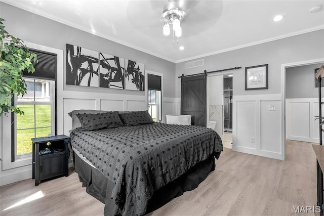 28 Millwell Dr, Maryland Heights, MO 63043 - bedroom featuring a barn door, light wood finished floors, a decorative wall, ornamental molding, and a wainscoted wall