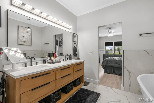 28 Millwell Dr, Maryland Heights, MO 63043 - full bathroom featuring marble look tile flooring, double vanity, ornamental molding, a freestanding bath, and ensuite bath