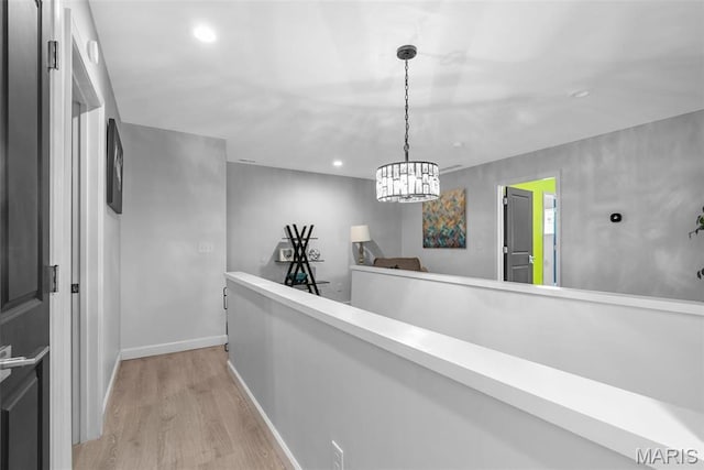 28 Millwell Dr, Maryland Heights, MO 63043 - hallway with light wood-type flooring, recessed lighting, a chandelier, and an upstairs landing