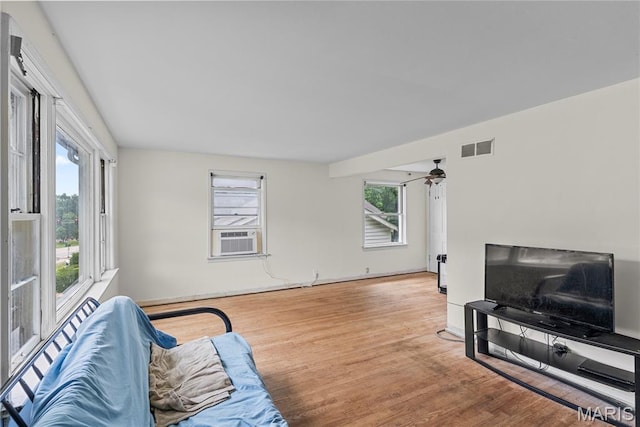 1937 N Hanley Rd, Saint Louis, MO 63114 - living room with wood finished floors, cooling unit, and a ceiling fan