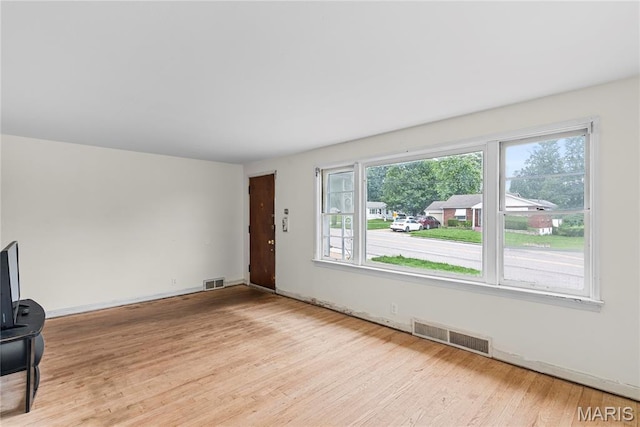 1937 N Hanley Rd, Saint Louis, MO 63114 - unfurnished living room with wood finished floors and baseboards