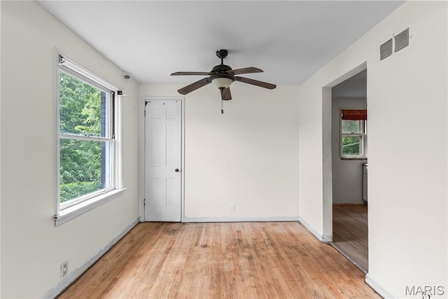 1937 N Hanley Rd, Saint Louis, MO 63114 - empty room featuring plenty of natural light, light wood-type flooring, and a ceiling fan